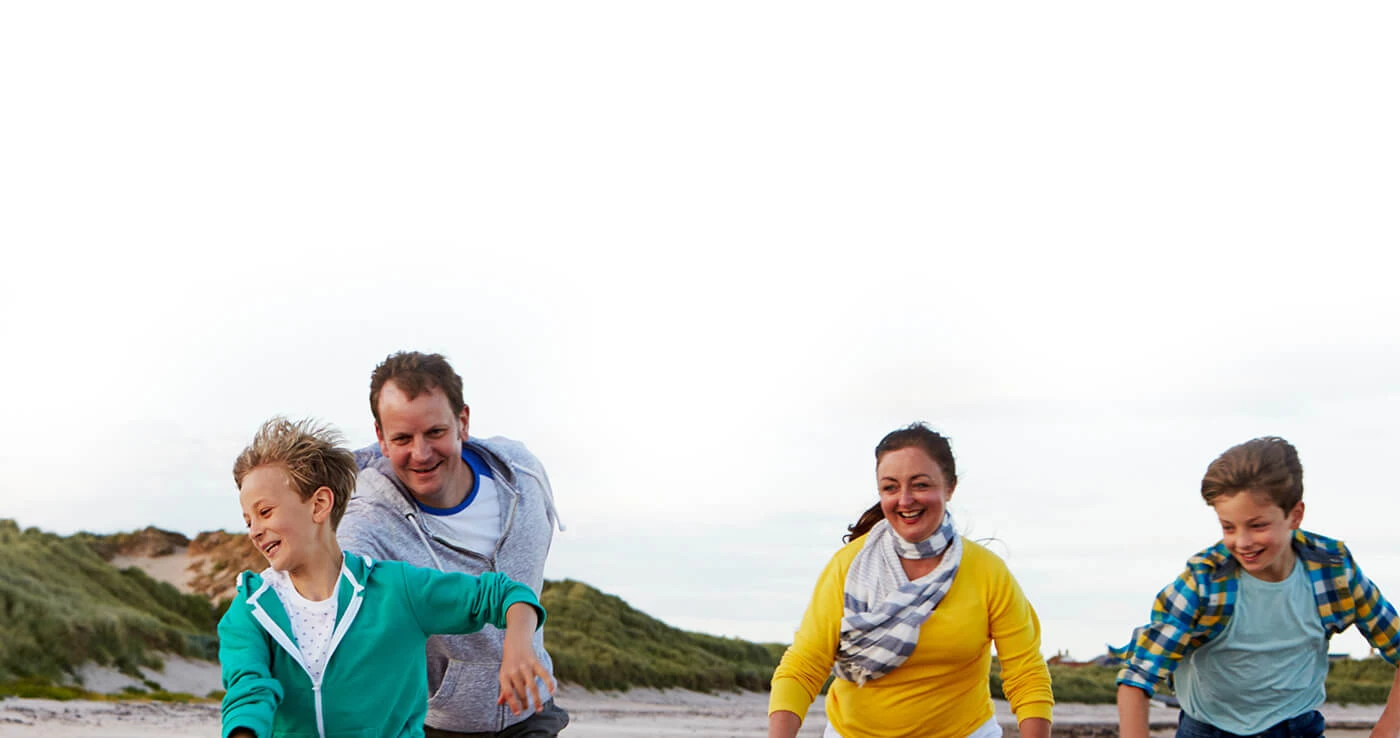 family-playing-on-beach