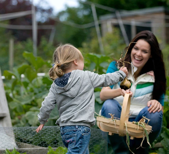 child-and-adulting-harvesting-vegetables