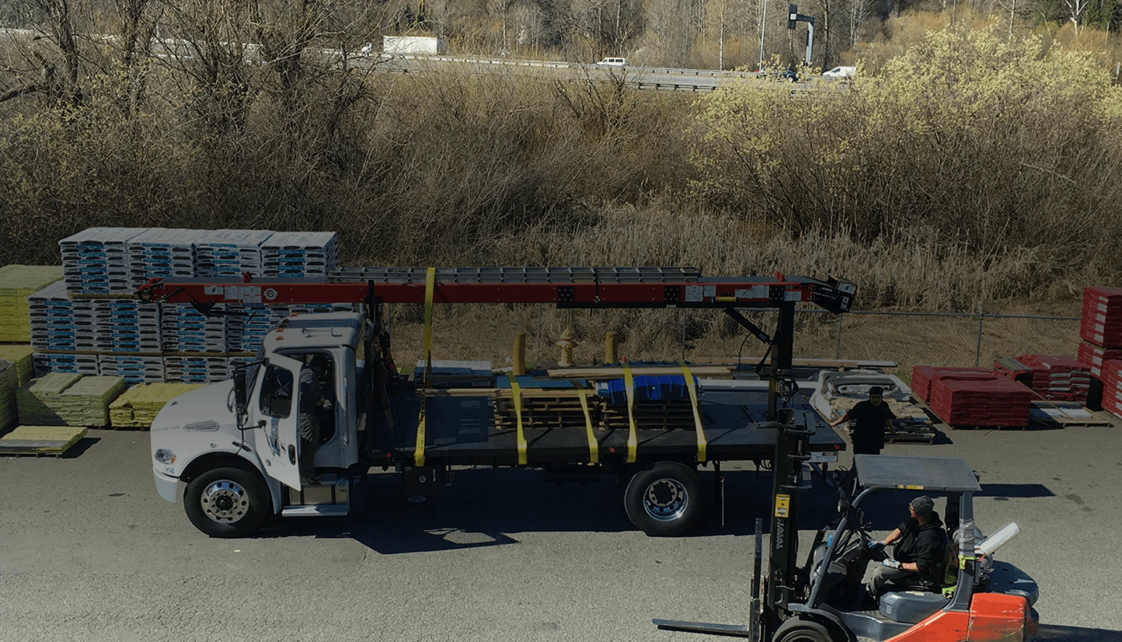 trucking-being-loaded-with-roofing-material
